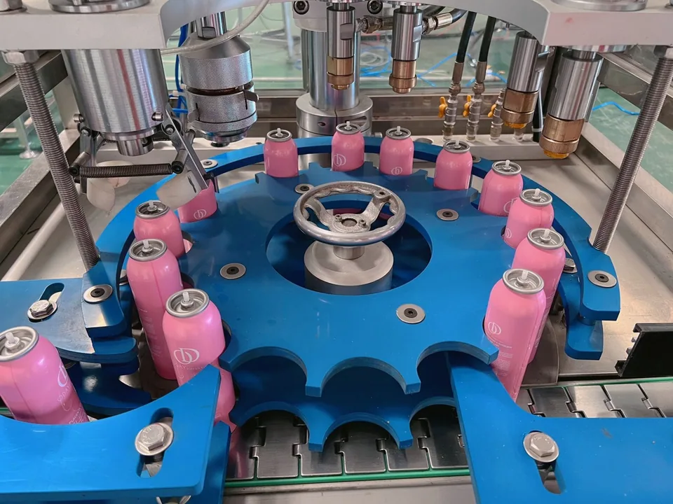 Pink aerosol cans on a conveyor, view 03