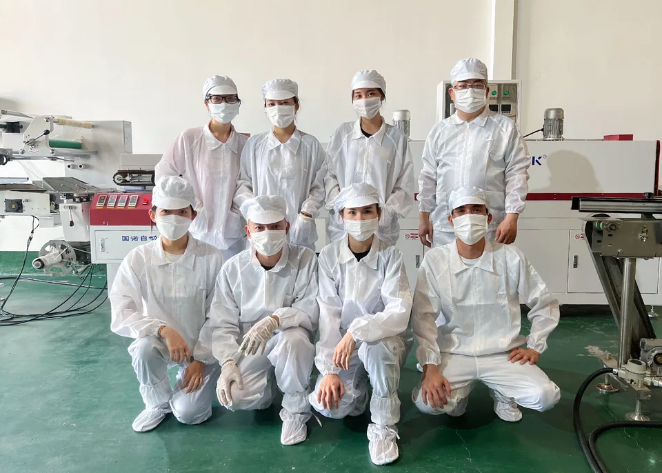 Production team members in a light-coloured factory space